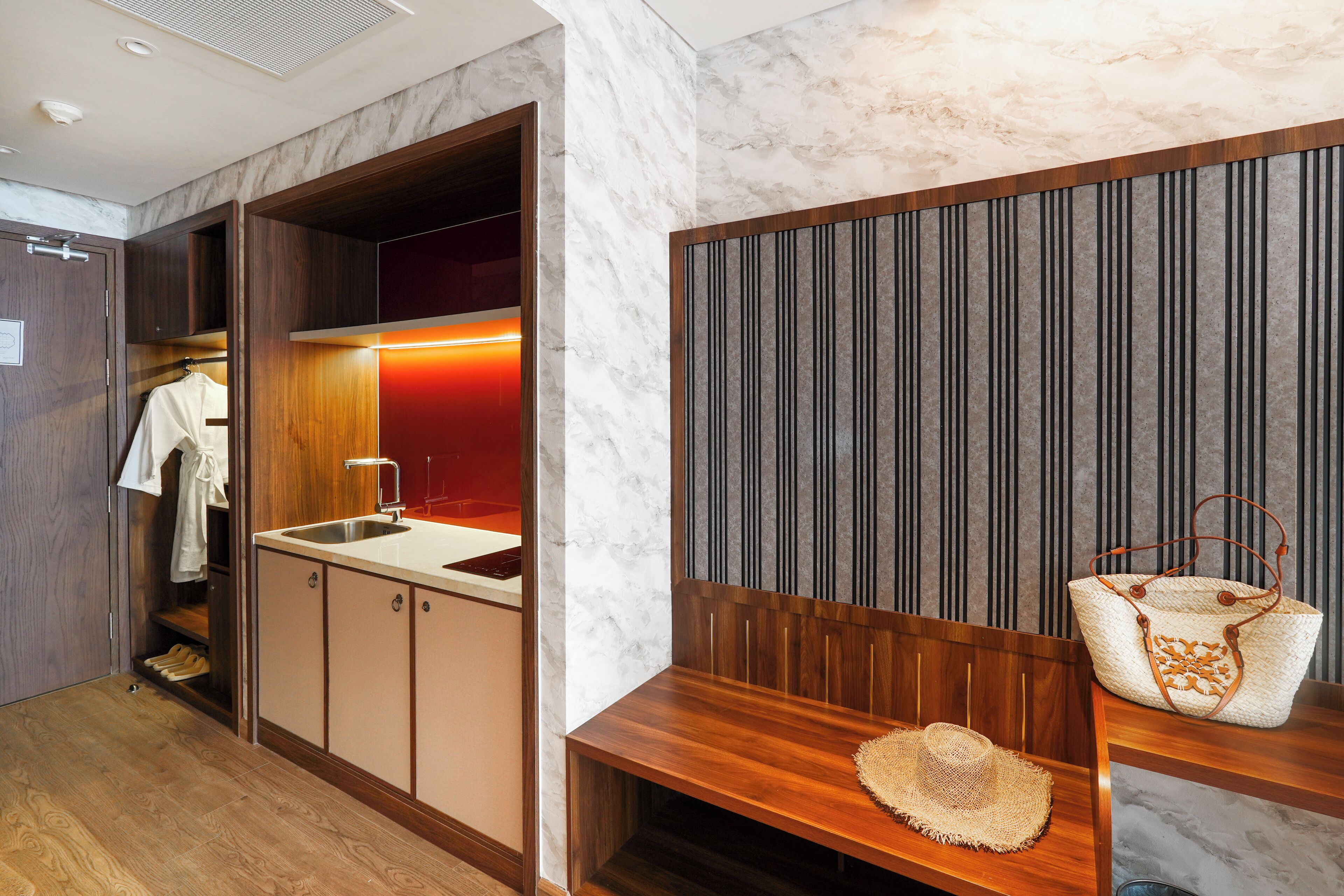A modern bathroom with a wooden vanity, a sink, and a mirror.