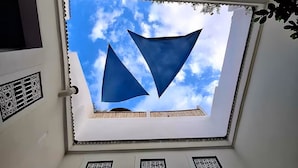 A skylight with a geometric design and a view of the sky.