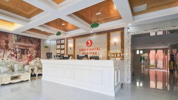 A hotel reception area with a marble reception desk, a large mural on the wall, and a classic sofa. - Vienna 3 Best Hotel (Beijing)