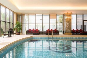 An indoor swimming pool with seating areas and large windows. - Nine Cloud Homestead Resort Hotel (Tonglu)