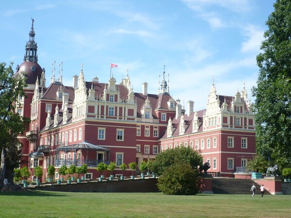 A large, historic building with multiple towers and a prominent dome.