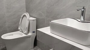 A modern bathroom with a toilet and a sink. - Lanzhou Sapphire Hotel (Lanzhou)
