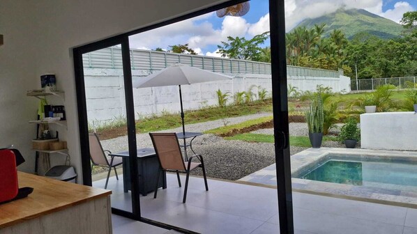 Enjoy an outdoor space with a pool, seating area, and mountain views.
