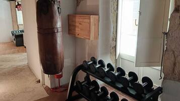 Ein Fitnessraum mit einem Sandsack und einem Gewichtsheberbock.
