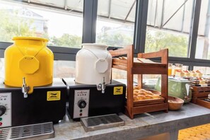 A breakfast station with coffee dispensers, a bread rack, and a variety of pastries. - Super 8 Hotel (Beijing Peking University Hospital Gaomidian North Subway Station) (Beijing)