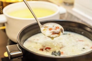 A spoonful of soup being lifted from a pot. - Super 8 Hotel (Beijing Peking University Hospital Gaomidian North Subway Station) (Beijing)