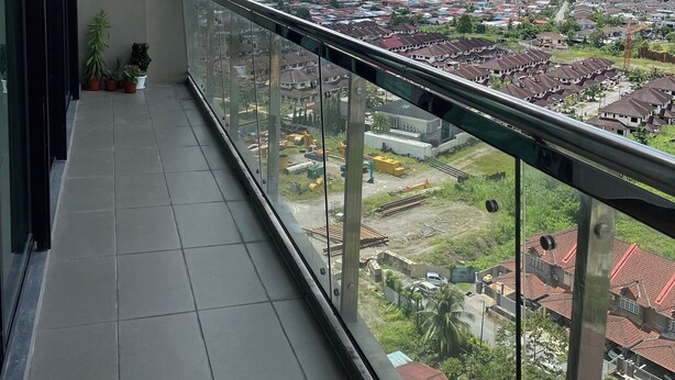 A balcony with a clear view of a residential area, including houses and construction sites. - Spacious 3-bedroom apartment with AC, fitness room in charming Kuching (Kuching)