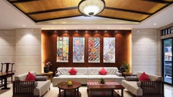 A modern living room with a sofa set, two side tables, and a coffee table.