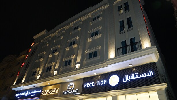 A hotel with multiple floors, a reception area, and signs for 'Zan Bride' and 'MedCoat'. - Onesen Serviced Apartments 4 (Dammam)
