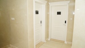 A hallway with two white doors, each marked with a room number (212 and 211).