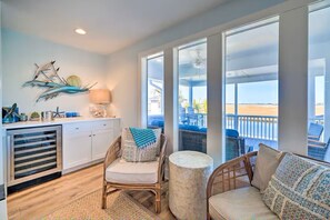 Relax in a comfortable seating area with wicker chairs and a round ottoman, or cook in a well-equipped kitchen with appliances.
