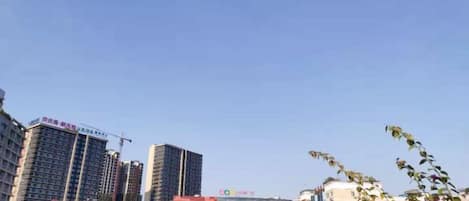 A cityscape with high-rise buildings, including a hotel with a prominent sign.