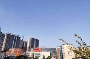 A cityscape with high-rise buildings, including a hotel with a prominent sign.