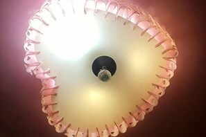 A ceiling light fixture with a circular design and a central control knob. - Dingding Hotel (Shanghai New International Expo Center Huaxia East Road Subway Station) (Shanghai)