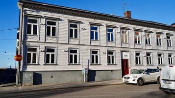 A two-story building with a classic architectural style, featuring symmetrical windows and a central entrance.