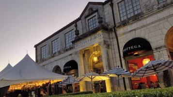 A historic building with arched entrances and a sign reading "Bottega."
