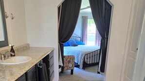 A compact hotel room with a bathroom, a bed, and a small sitting area. - Affordable Pollyanna Ridge, By Norris Lake & Dam St Pk & ATV trails. 3BR 2Bath (Rocky Top)