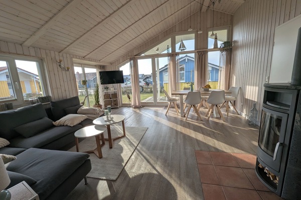 Wohnzimmer mit Kamin, Smart-TV, Esstisch für sechs Personen und Kamin