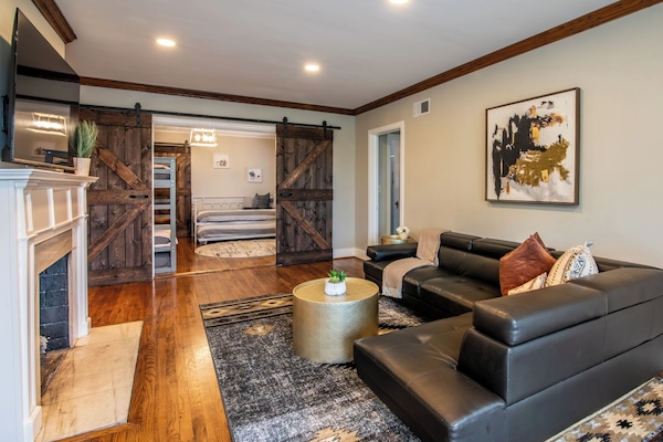 Our charming living room at the Glen Iris Garden Haven is a cozy and inviting space where you can relax and unwind after a day of exploring. Get in touch to explore our custom concierge services and local experiences curated just for you.