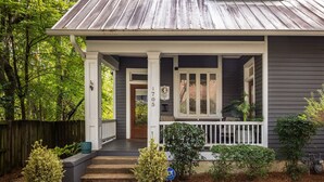 A two-story house with a porch, a number 1705 sign, and a small garden with potted plants. - Warren Home: A Glimpse into BHAM's Rich Past (birmingham)