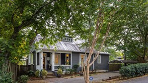 A two-story house with a porch, a covered porch area, and a garage. - Warren Home: A Glimpse into BHAM's Rich Past (birmingham)