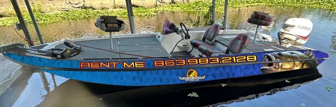 A blue boat with a 'RENT ME' sign and a contact number.
