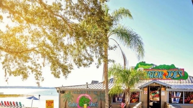 A beachside restaurant named Gator Joes with a wooden boardwalk leading to the entrance. - Cozy Cottage At Lake Weir (Ocklawaha)