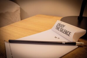 A notebook with a pencil on a wooden table. - Treehouse by Wynwood House (Lima)