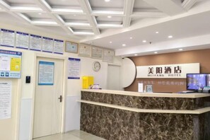 A hotel reception desk with a marble counter, a clock, and various informational posters on the walls. - Meiyang Boutique Hotel (Shijiazhuang Xinhua Road 54 Office) (Shijiazhuang)