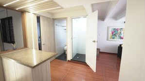 A modern bathroom with a shower, toilet, and sink.