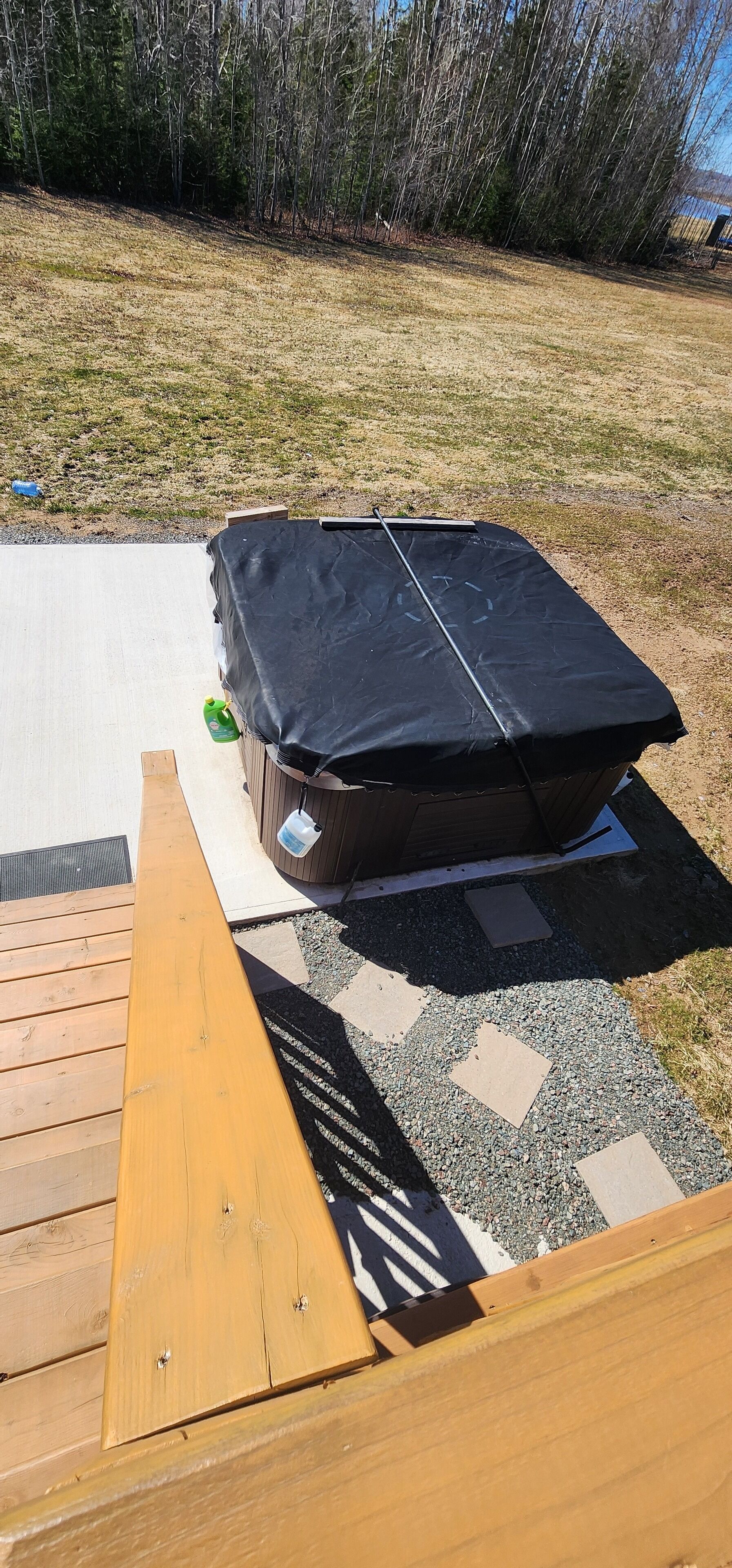 A wooden deck with a covered outdoor seating area.