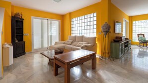 A living room with a sofa, coffee table, and a cabinet. - Villa Paraíso in Mojácar with pool for 14 guests – 7 bedrooms – 3.5 bathrooms (Mojácar)