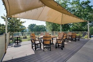 An outdoor patio with a table and chairs, a large canopy, and a railing. - Gorgeous and ALL NEW, Resort, Pools, Lake, Branson (Branson)
