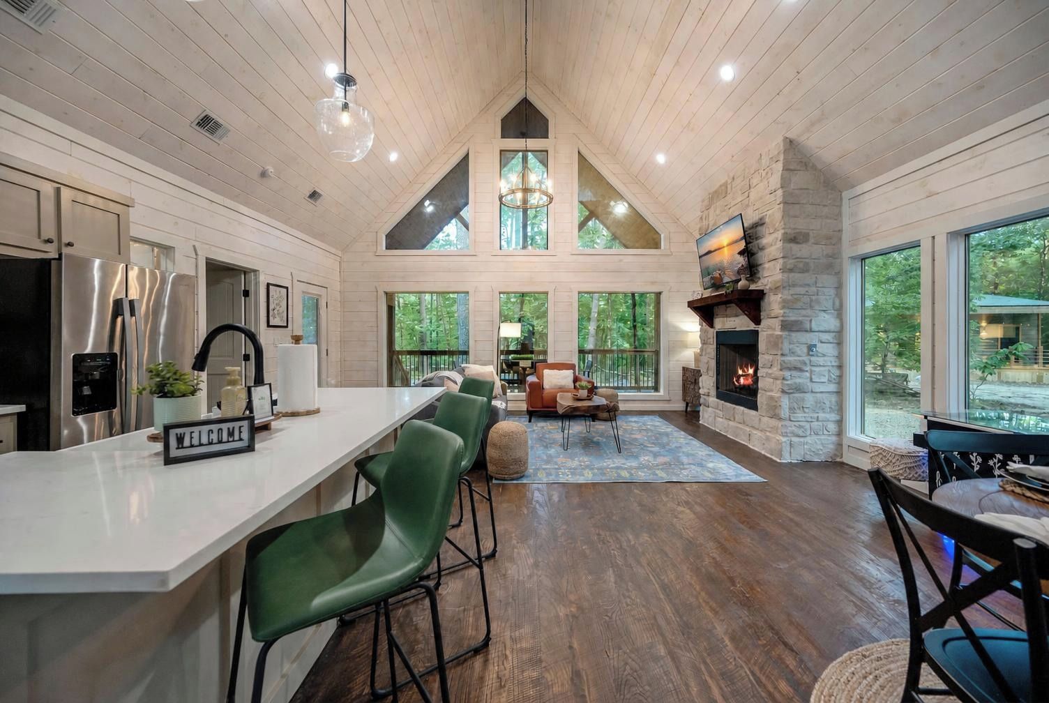 A spacious interior with a kitchen, dining area, and a fireplace.