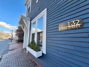 A building with a sign reading '132 SPRING STREET' and a window with a white frame. - Amazing West End apartment walkable to downtown and the waterfront. (Portland)