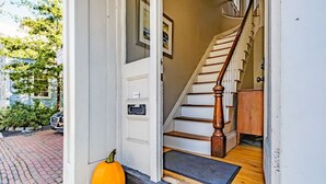 A staircase with wooden steps and a wooden handrail leading to an upper floor. - Amazing West End apartment walkable to downtown and the waterfront. (Portland)