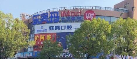 A building with multiple signs, including a prominent 'Wick' sign, and a 'Wick' logo.