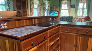 A kitchen with wooden cabinets, a tiled backsplash, and a large island.