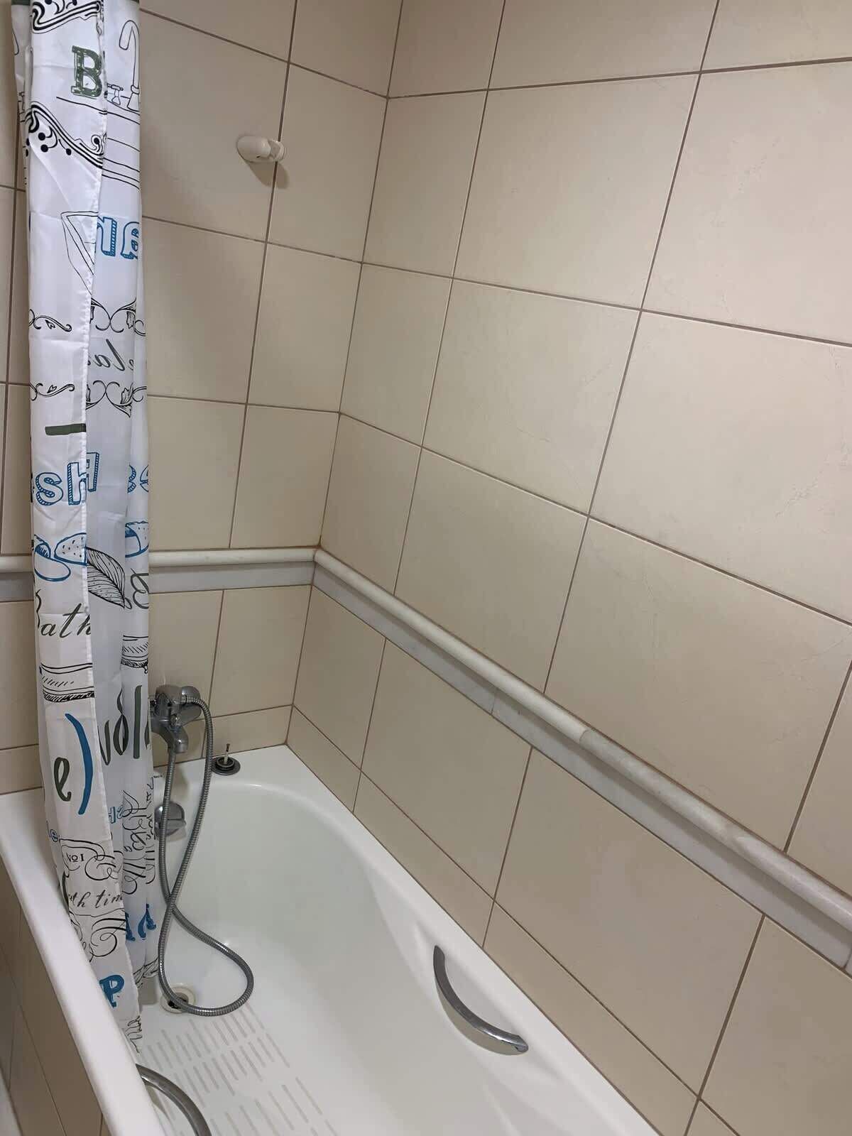 A bathroom with a bathtub, a shower, and a toilet.