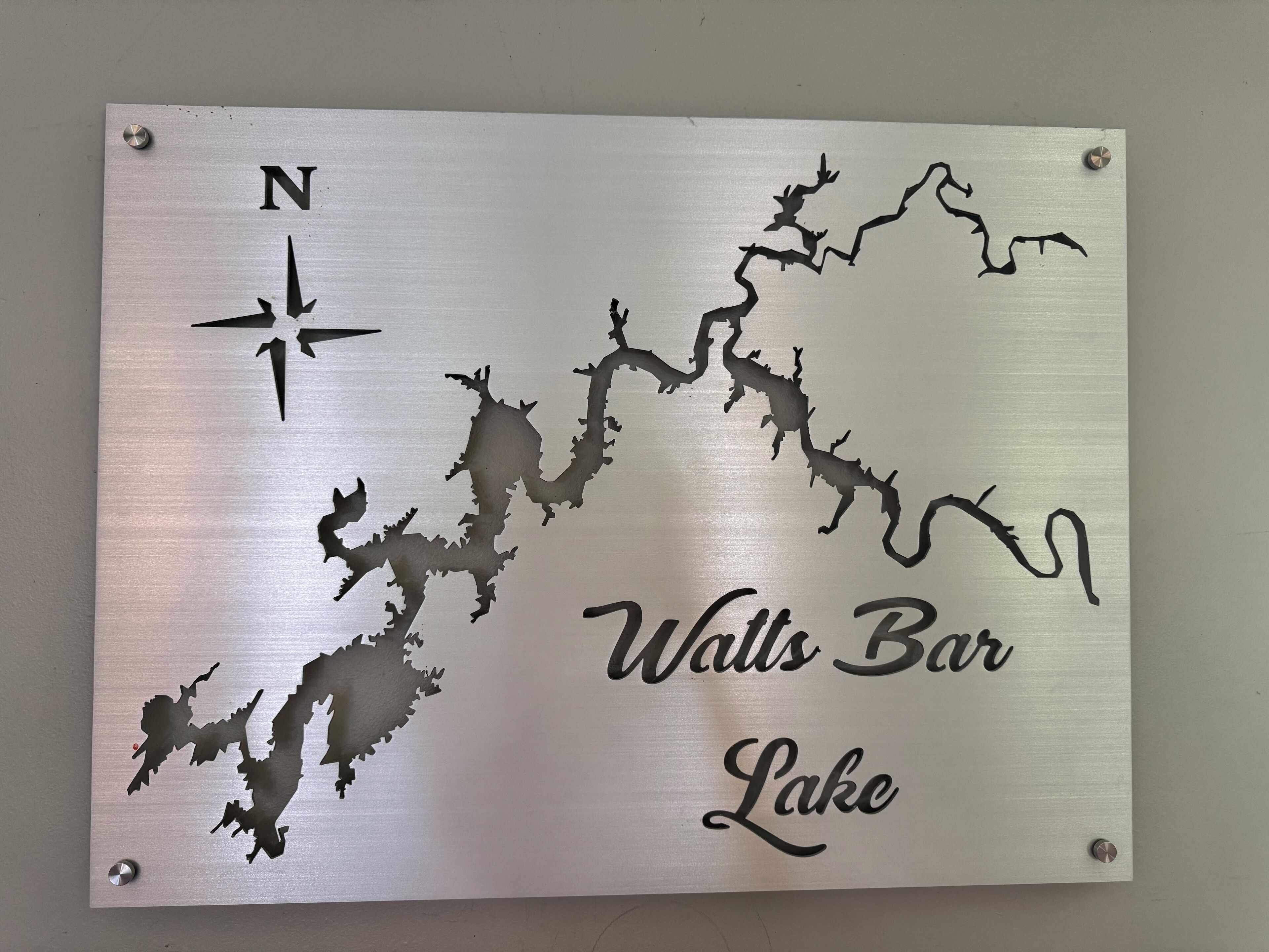 A metal sign with a map of a lake and the text "Waltz Bar Lake."