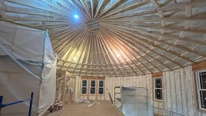 A construction site with exposed wooden beams and insulation material. - The Ca BIN (Charleston)
