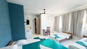 A hotel room with two beds, a desk, a chair, a ceiling fan, and a view of the outside. - Big Hotel - Florianopolis continental (Florianopolis)