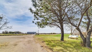 A gravel path leading to a building, surrounded by grassy areas and trees. - Dog-Friendly Miller Hunting Retreat! (Miller)