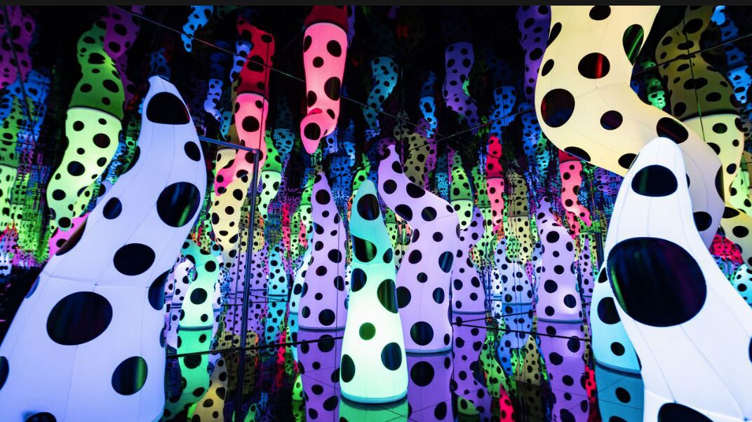 A ceiling with colorful, polka-dotted, abstract shapes.