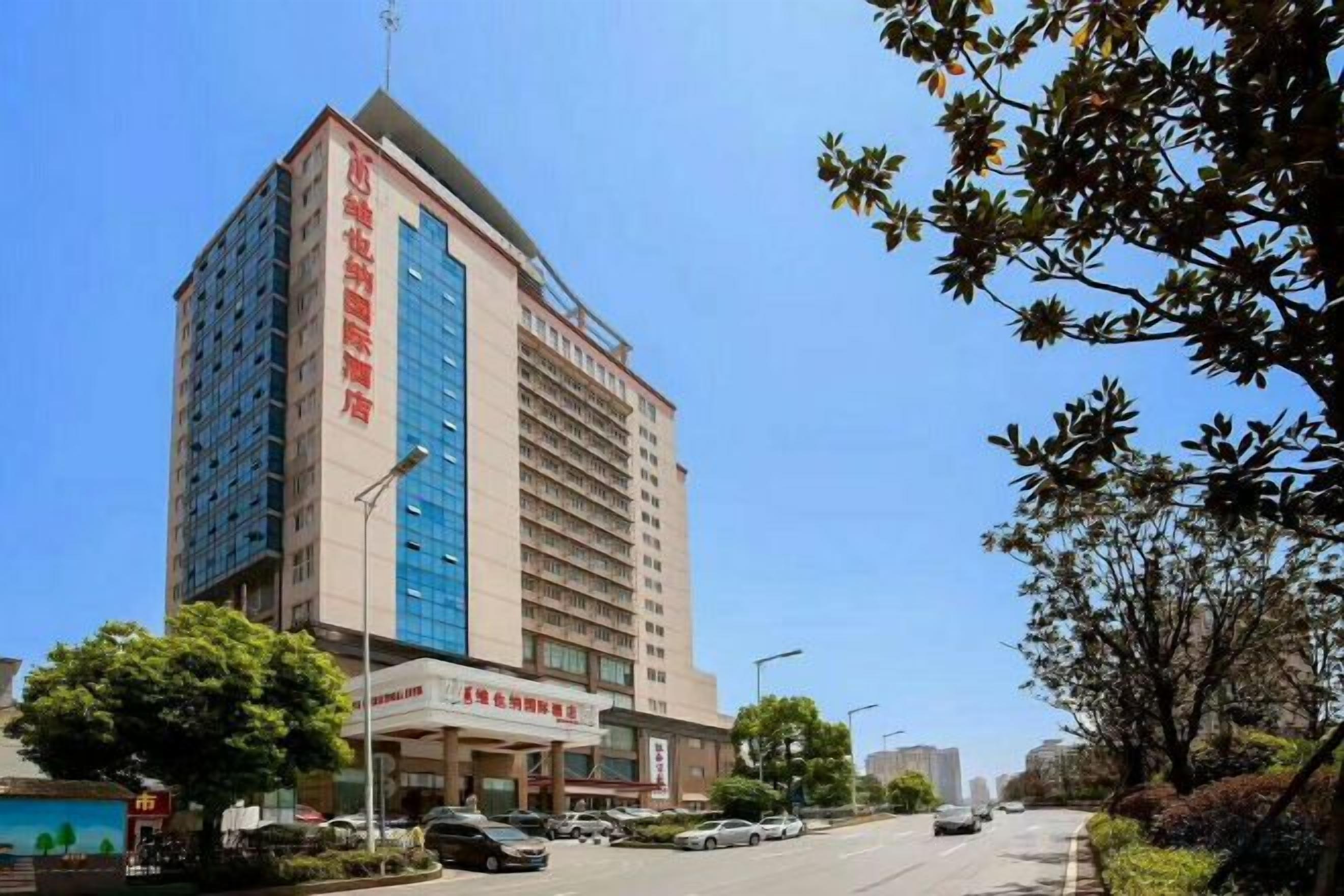 A multi-story hotel with a prominent entrance and signage.