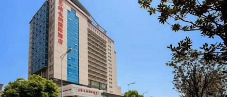 A multi-story hotel with a prominent entrance and signage.