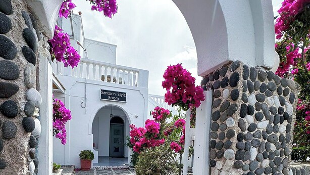 A stone pathway leading to a white building with a sign reading "Santorini Style Room". - Calypso Heaven (Santorini)