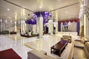A spacious lobby with a central seating area, a reception desk, and decorative columns. - Kunming HNA Flight Hotel (Kunming)