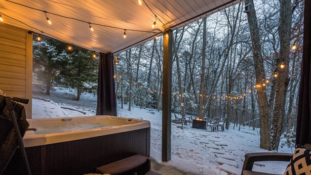 A cozy outdoor hot tub area with a view of a snowy forest. - 3800 sq ft of Fun! Sleeps 14 • Hot Tub • Pool Table • PAC-Man • Foosball  (McGaheysville)