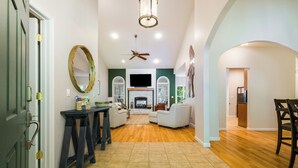 A spacious living area with a fireplace, seating, and a television. - 3800 sq ft of Fun! Sleeps 14 • Hot Tub • Pool Table • PAC-Man • Foosball  (McGaheysville)